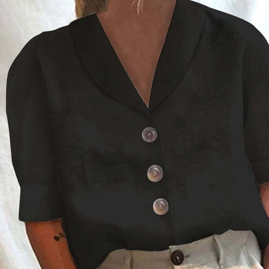 Black button-up shirt worn by a person with a neutral background