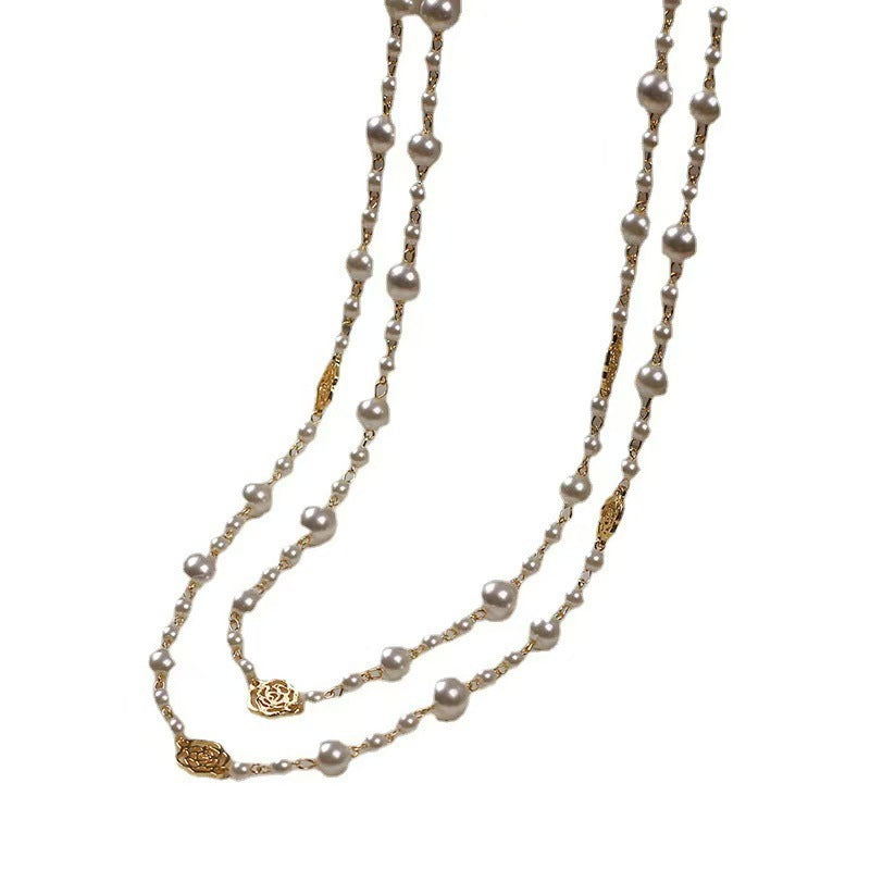 Two pearl necklaces with gold clasp on a white background