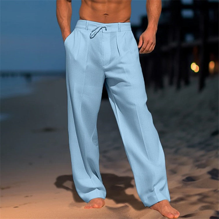 Person wearing light blue pants on a beach at night.