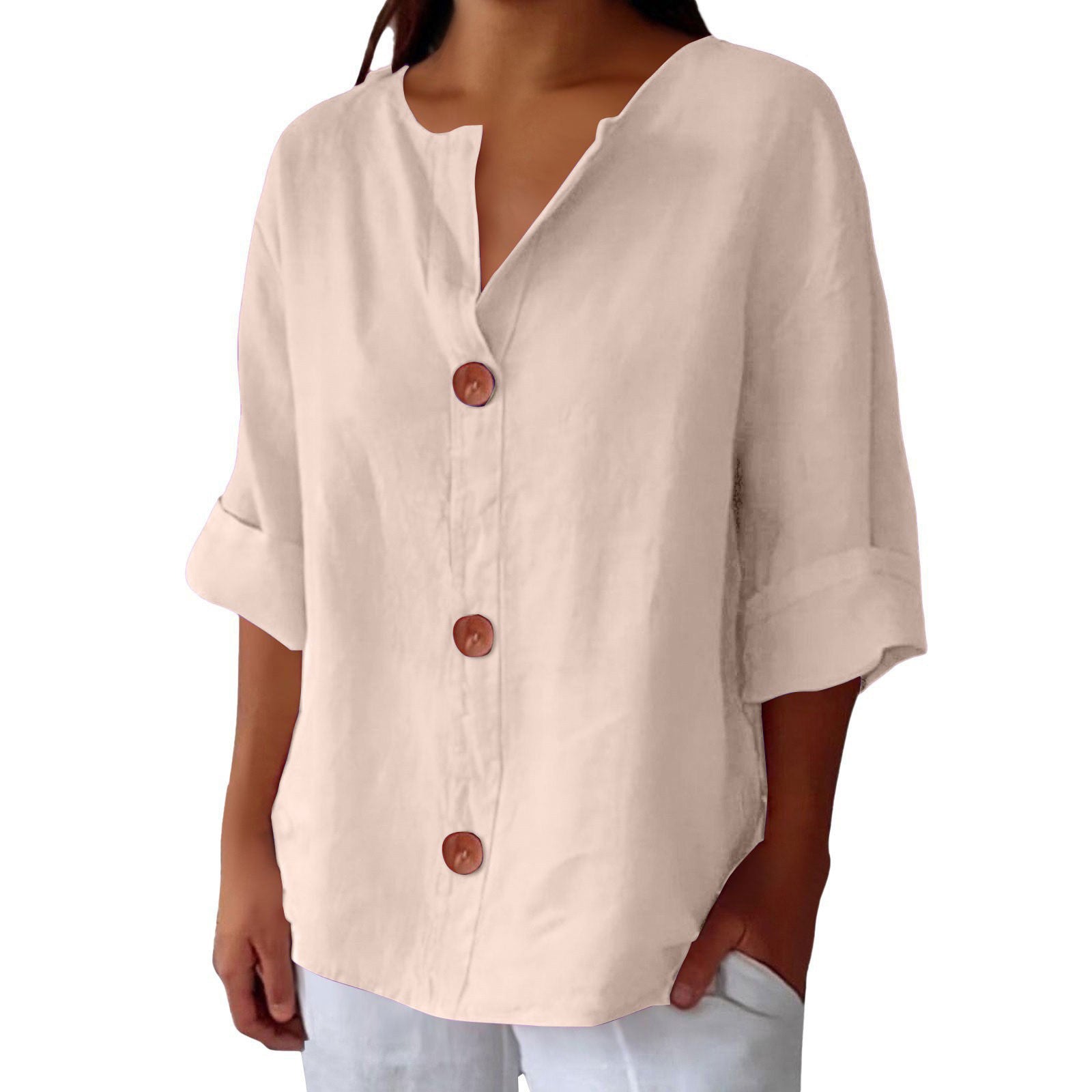 Beige button-up shirt worn by a person on a white background