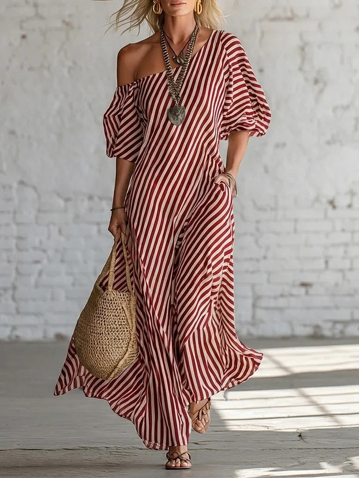 Woman wearing a red and white striped dress with a textured wall background