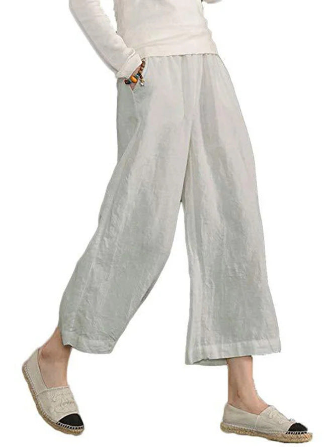 Light gray wide-leg pants worn by a person on a white background