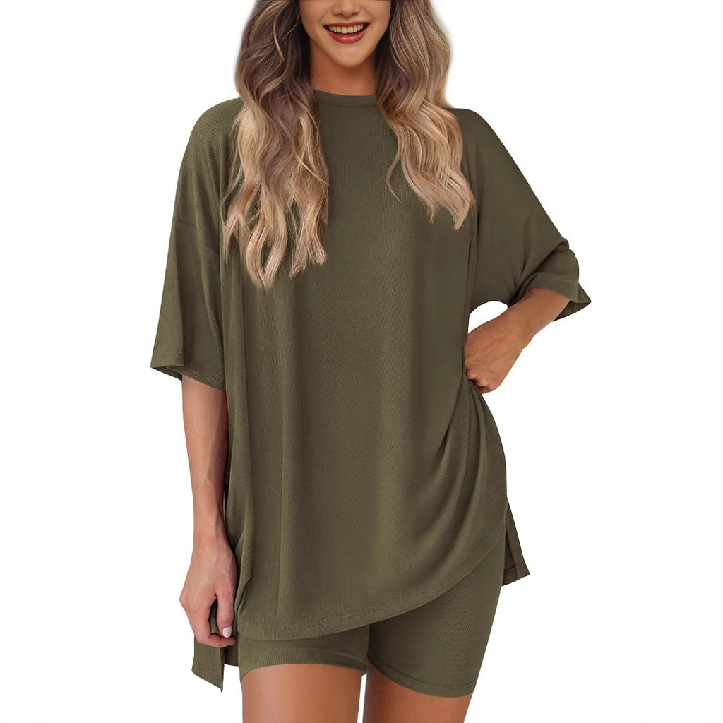 Woman wearing an olive green oversized t-shirt and shorts set on a white background