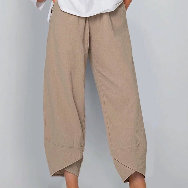 Beige wide-leg pants worn by a person on a plain background