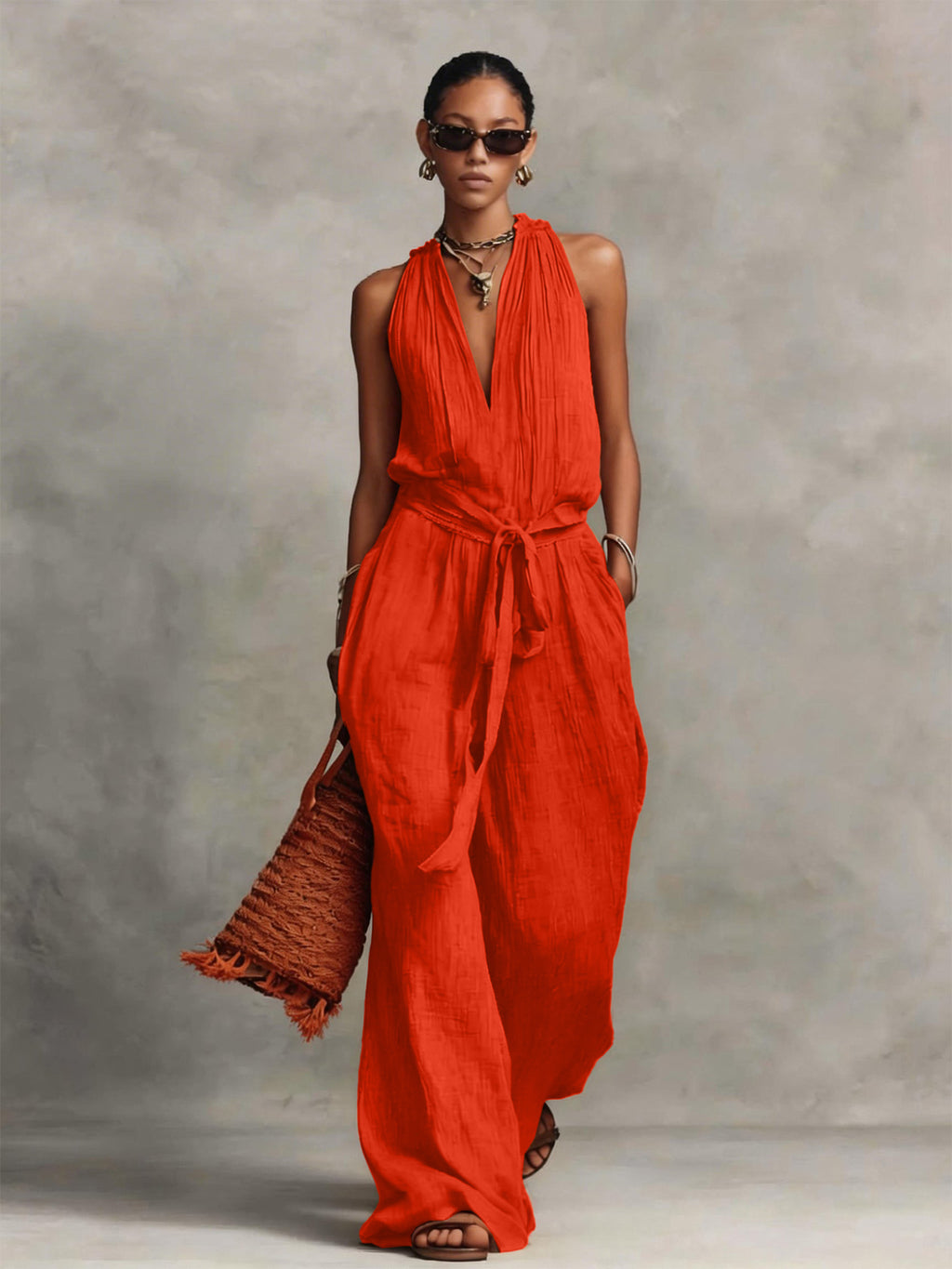 Woman wearing a red jumpsuit against a gray background