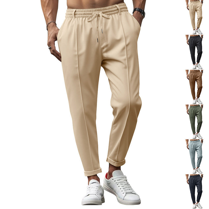 Beige jogger pants worn by a person with additional color options displayed below.