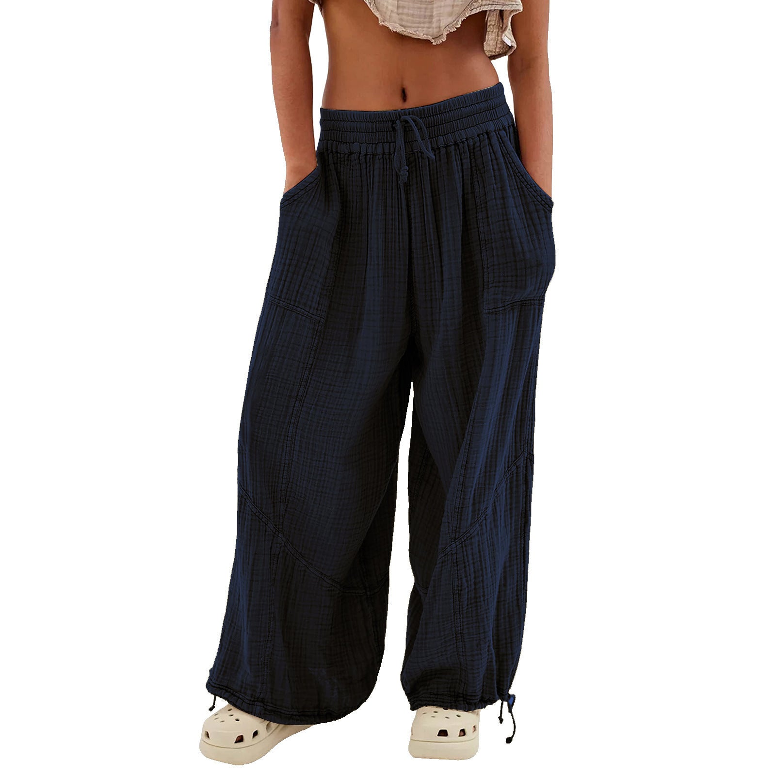 Navy blue wide-leg pants worn by a person on a white background