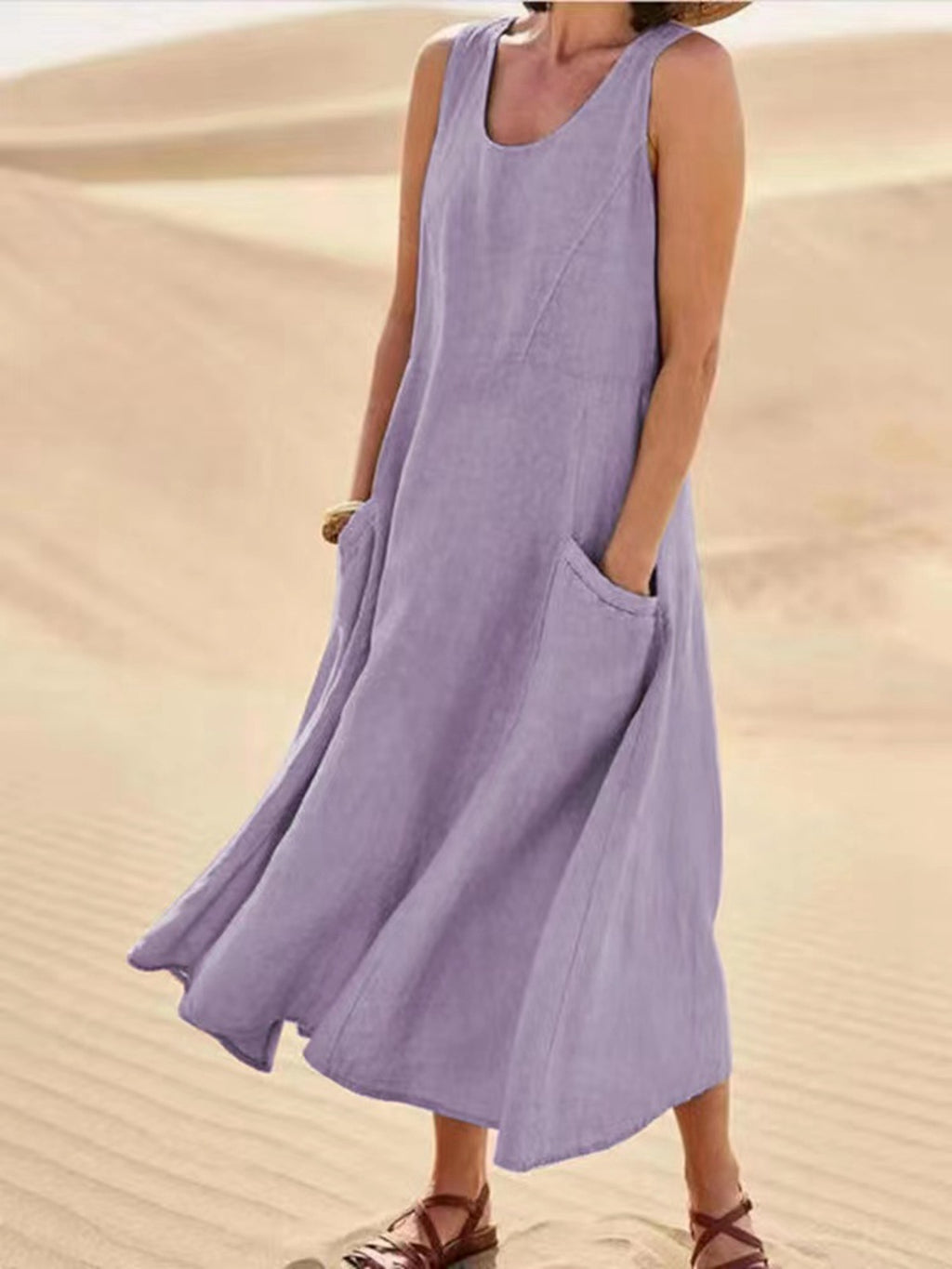 Person wearing a sleeveless purple dress in a desert setting