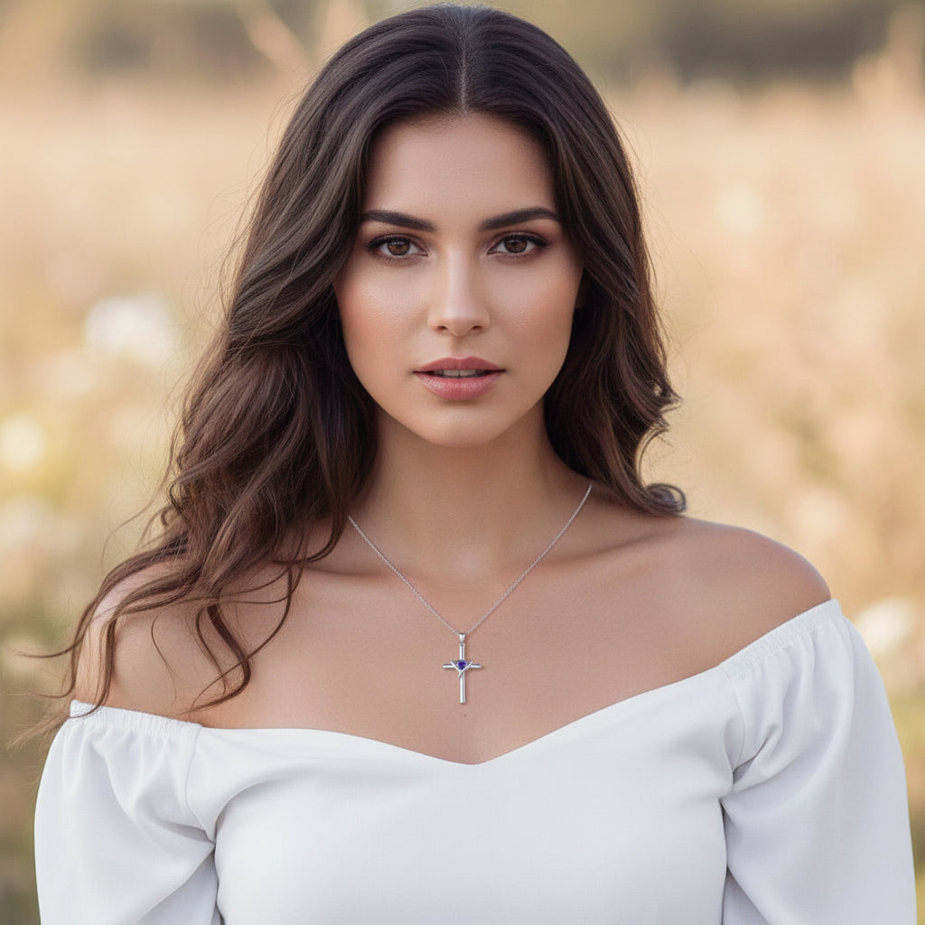 Woman wearing a necklace with a cross pendant, holding a plant against a blurred background