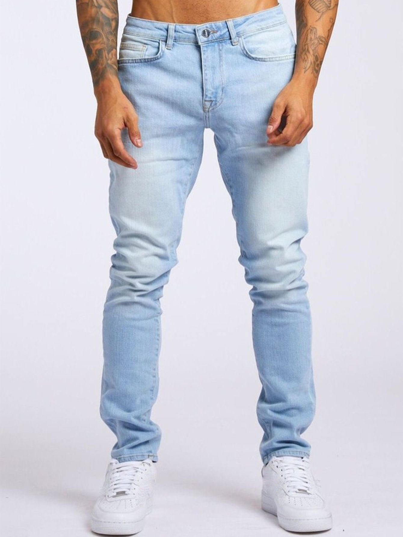 Light blue jeans worn by a person on a white background