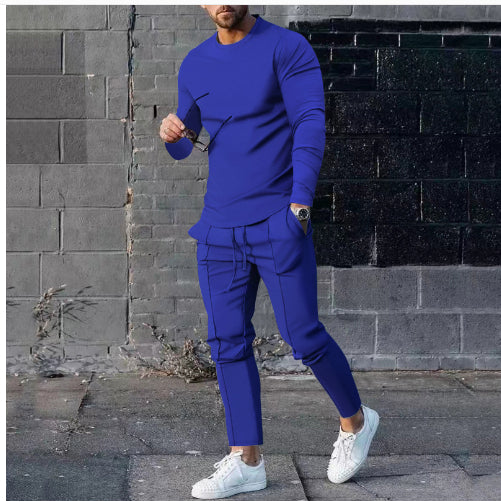 Person wearing a blue outfit standing against a brick wall.