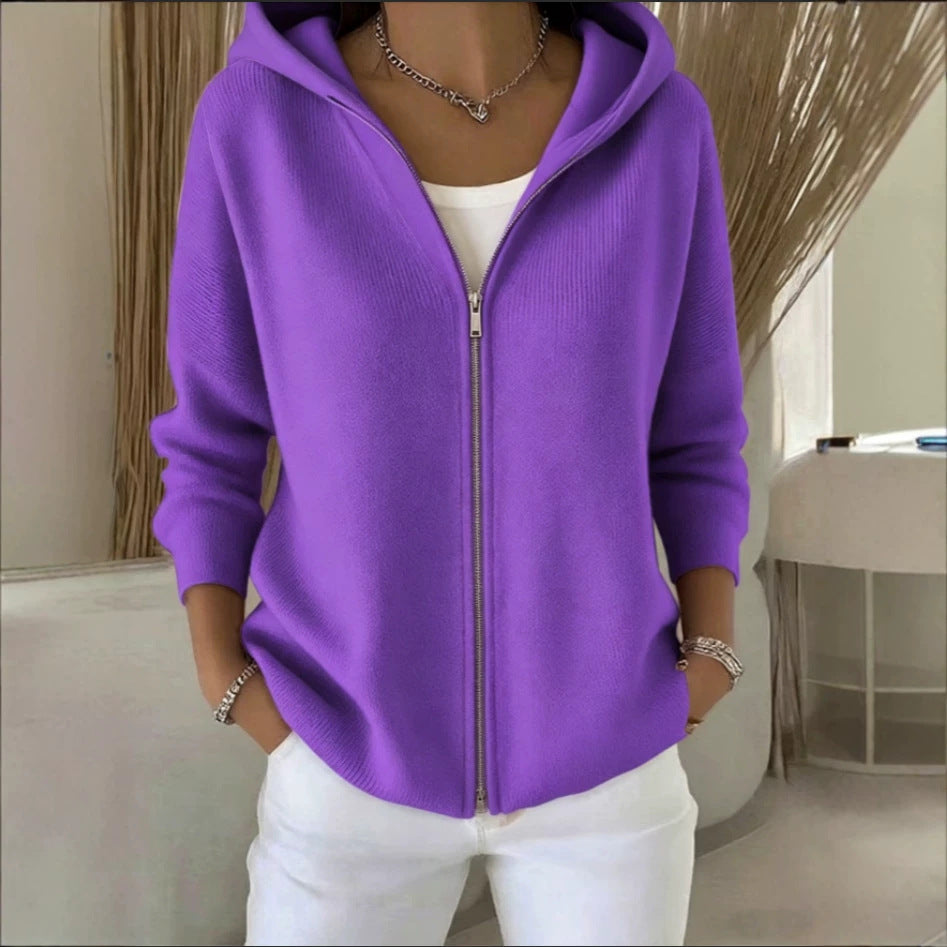 Person wearing a purple hoodie with a neutral background