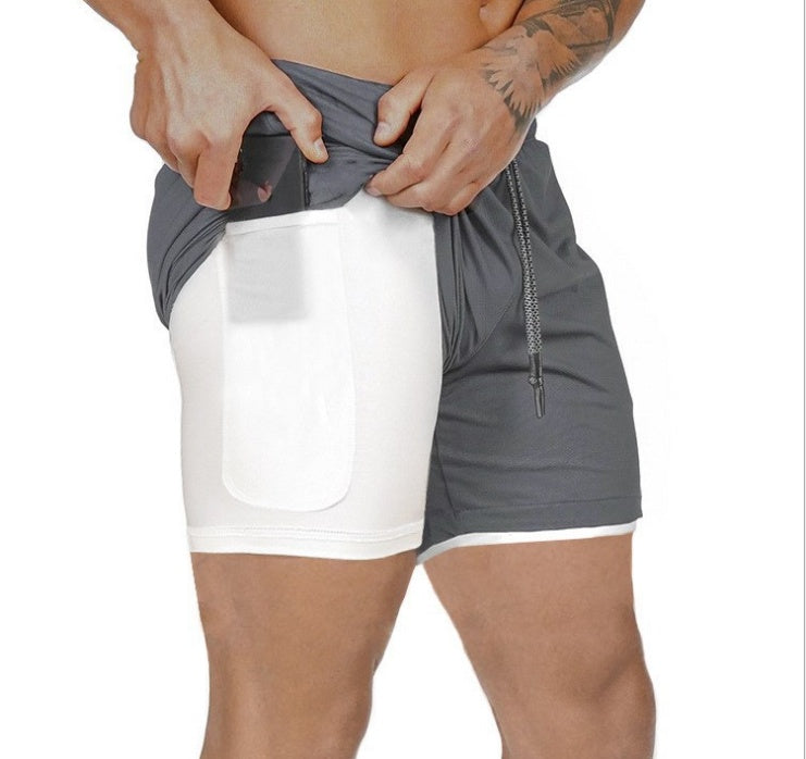 Gray and white athletic shorts with a person wearing them on a white background