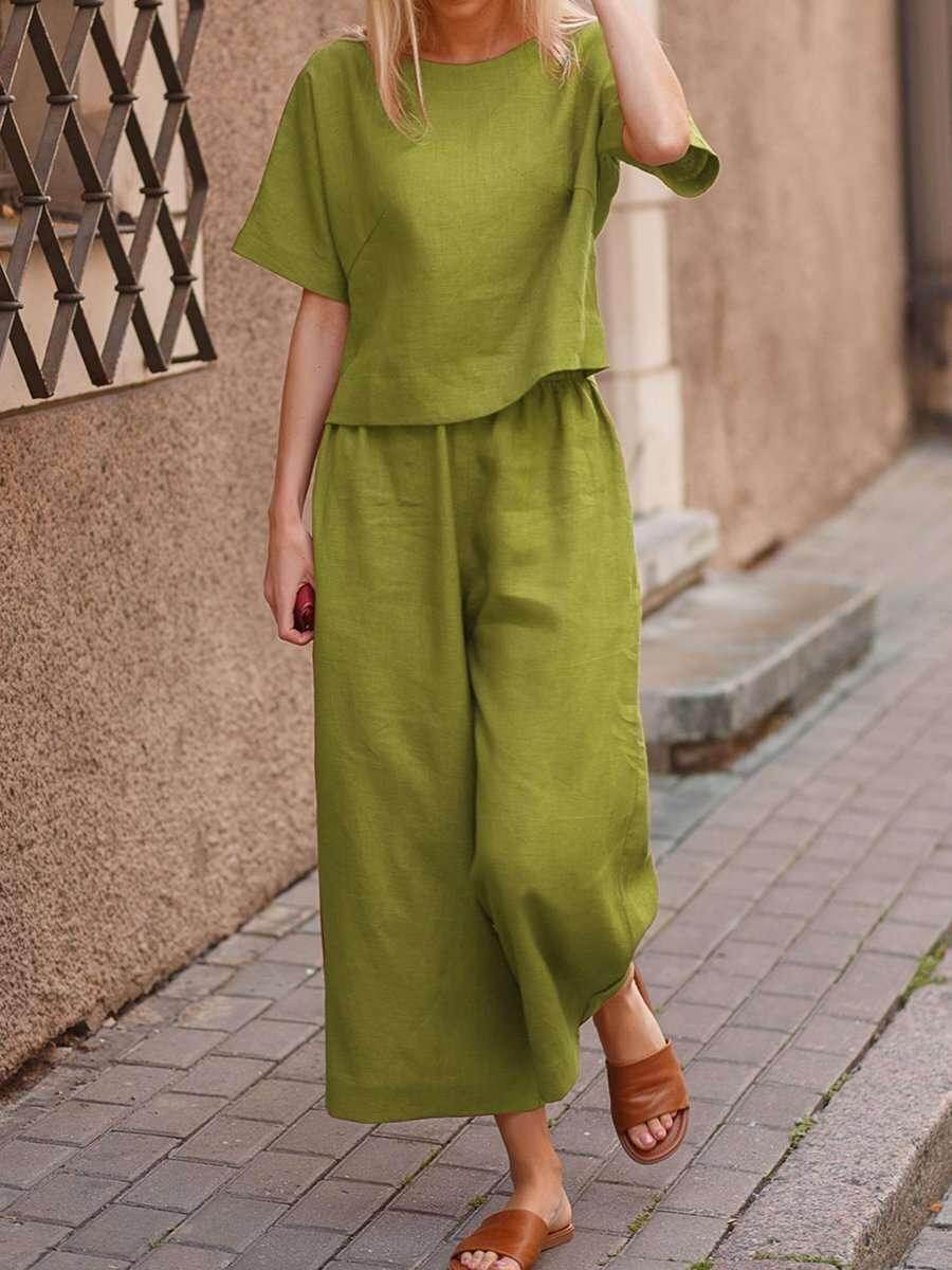 Woman wearing green linen two-piece outfit and brown sandals on city sidewalk, ZA-Zola fashion