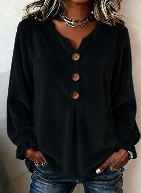 Black long-sleeve top with buttons worn by a person against a neutral background