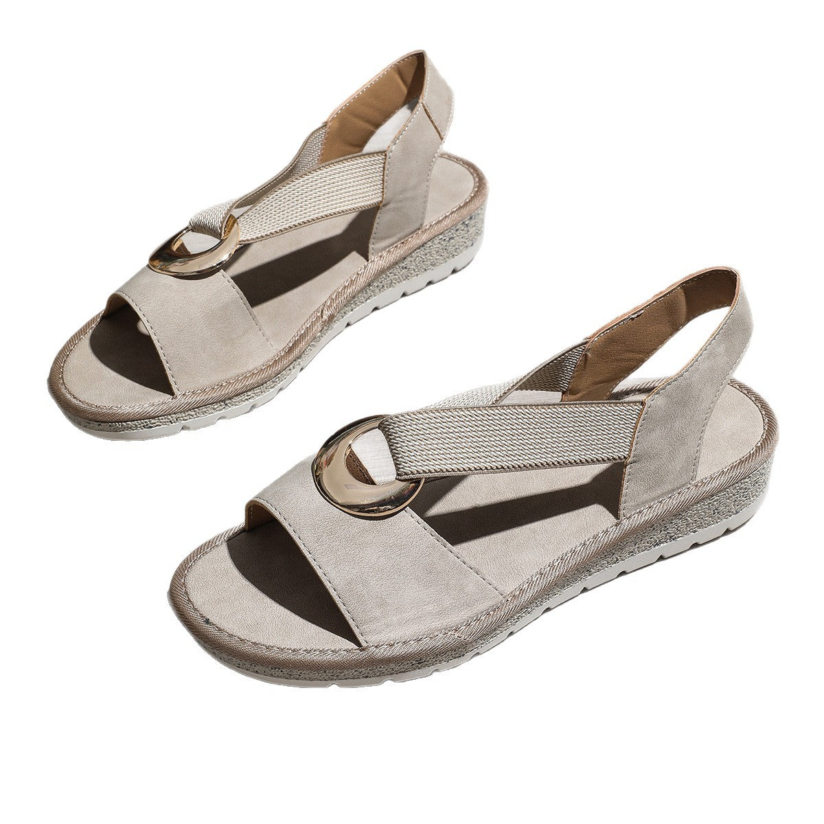 Pair of beige sandals with brown accents on a white background