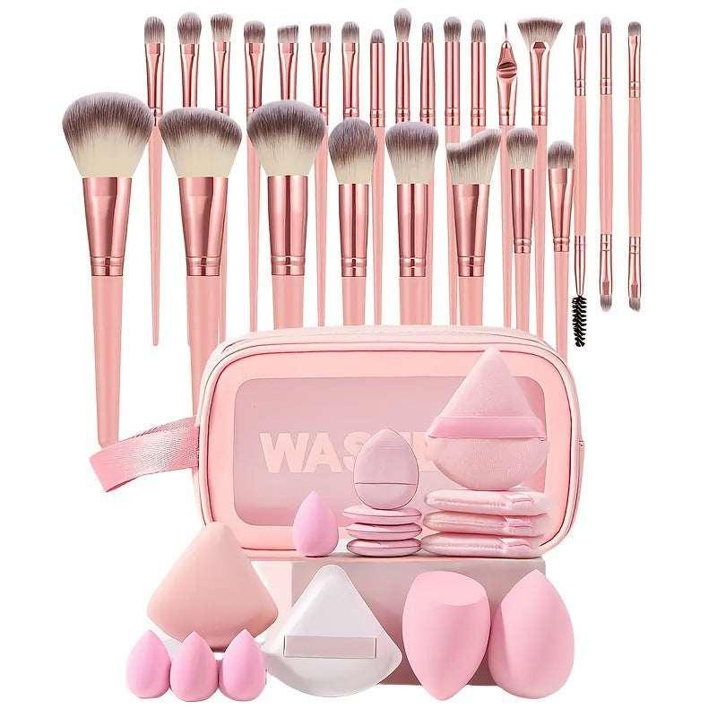 Pink makeup brush set with sponges, blending tools, and a matching cosmetic bag.