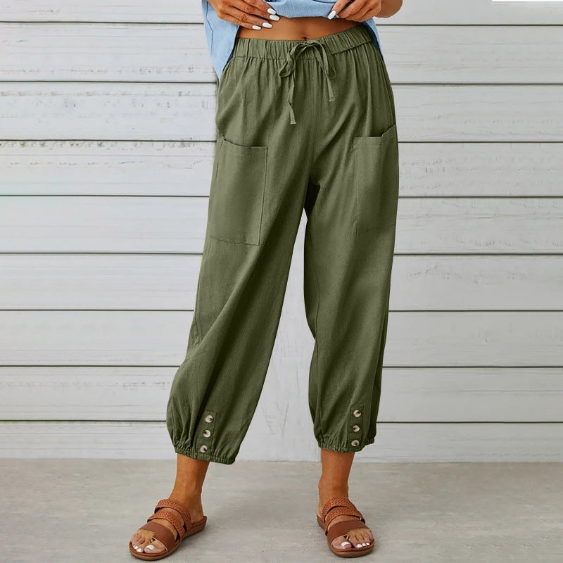 Green wide-leg pants worn by a person against a wooden background