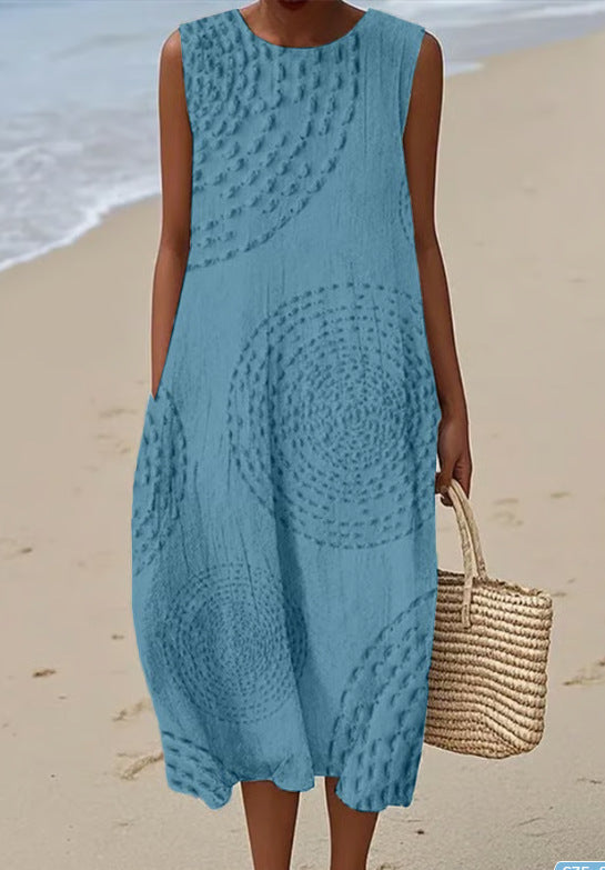 Woman wearing a blue crochet dress on a beach