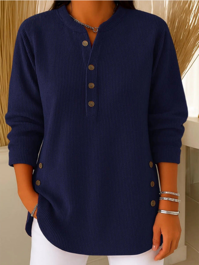 Navy blue ribbed sweater worn by a person with a neutral background