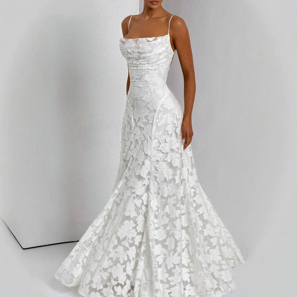 White lace wedding dress on a plain background