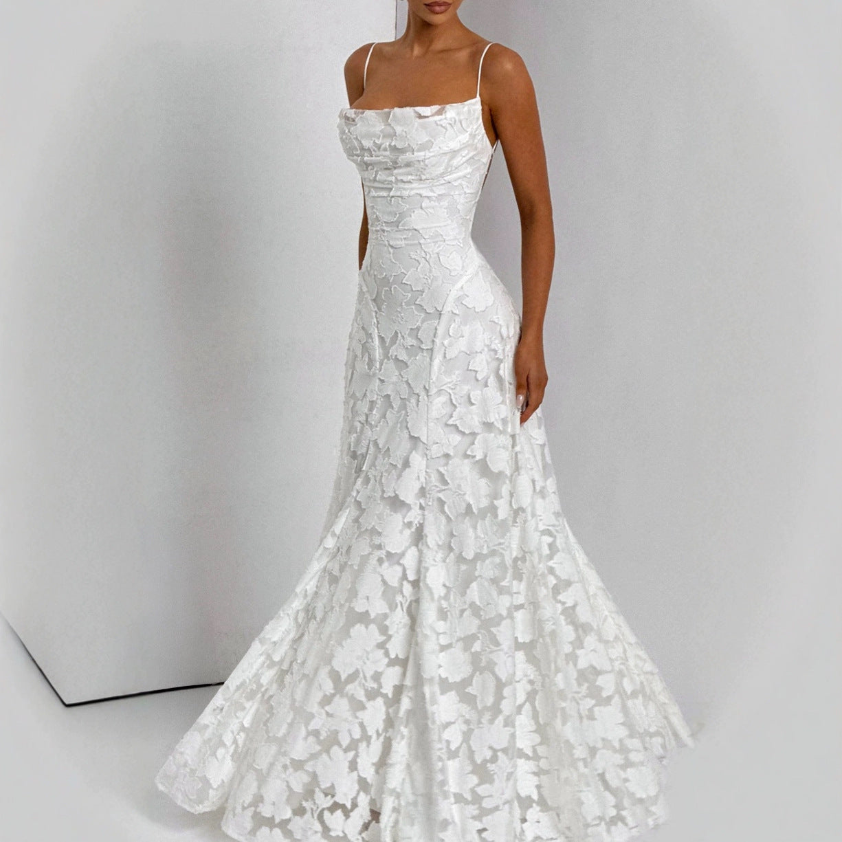 White lace wedding dress on a plain background