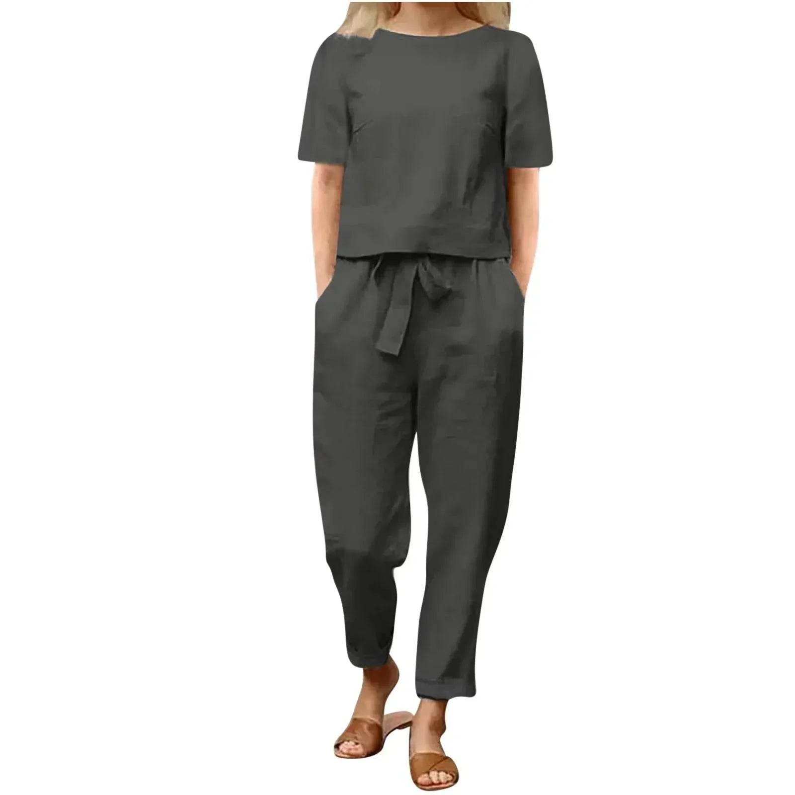 Woman wearing a black short-sleeve two-piece outfit with tied waist from ZA-Zola fashion