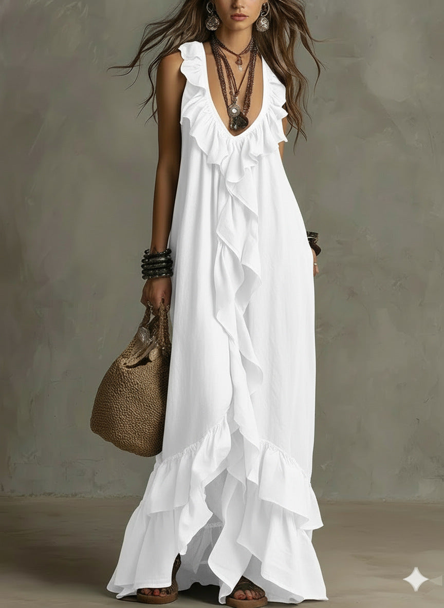 Woman wearing a white dress with ruffles against a neutral background