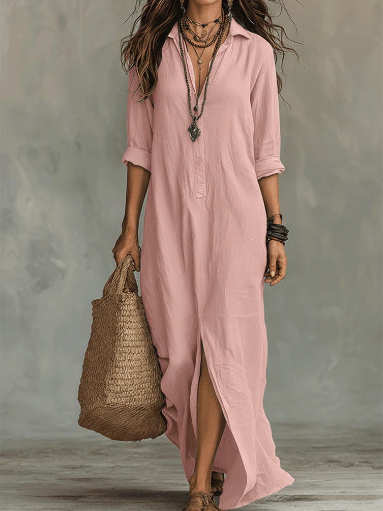 Woman wearing a long pink dress holding a woven bag against a neutral background