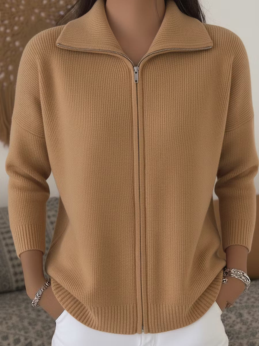 Brown zip-up sweater worn by a person with a neutral background