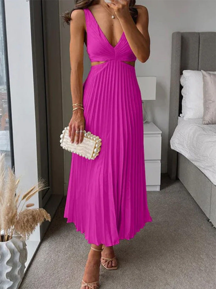Woman in a bright pink dress holding a pearl clutch in a bedroom setting.