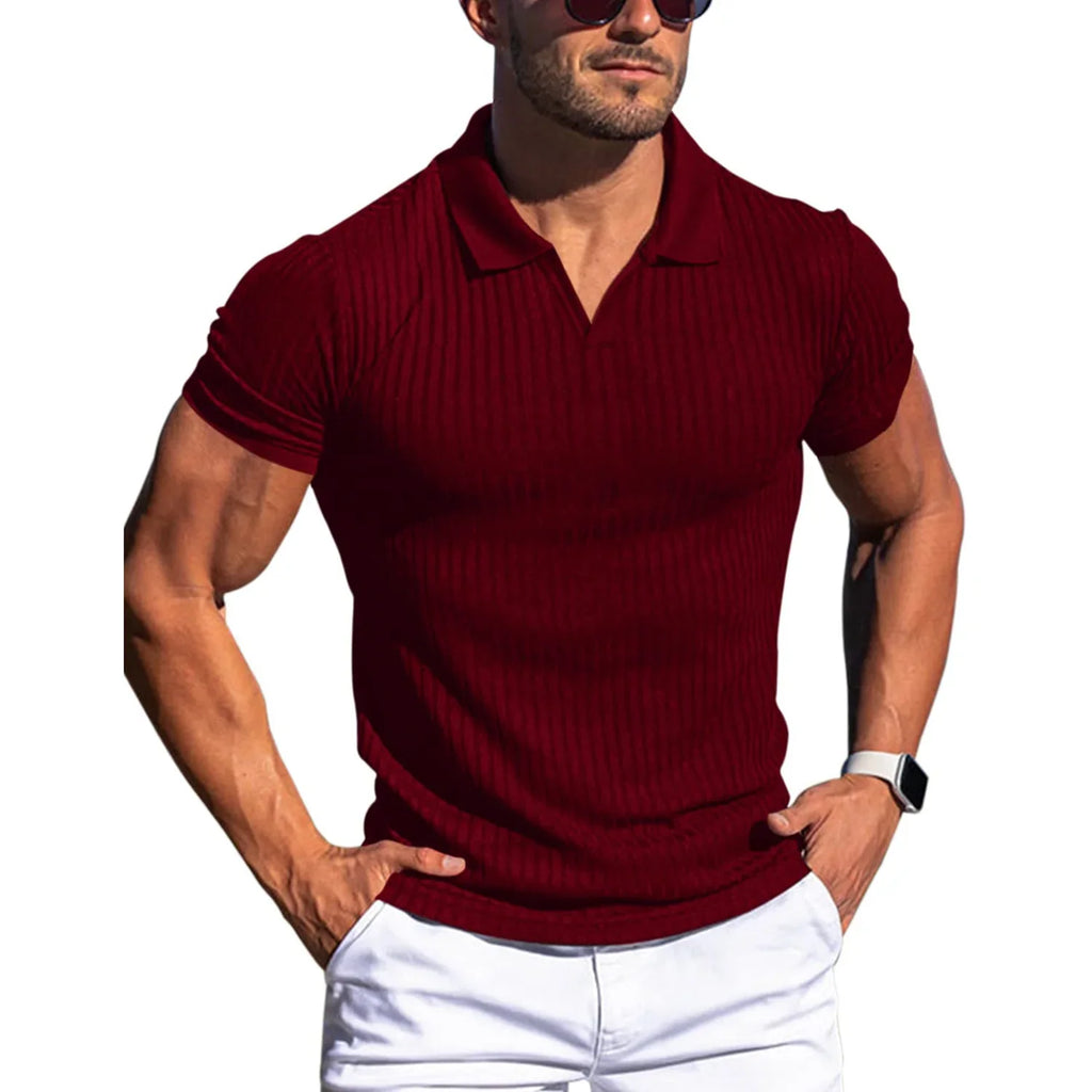 Man wearing a maroon ribbed polo shirt and white pants on a white background