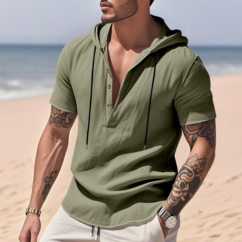 Man wearing a green hoodie on a beach