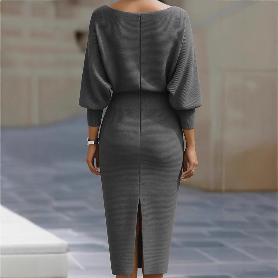 Gray dress with a slit on a blurred outdoor background