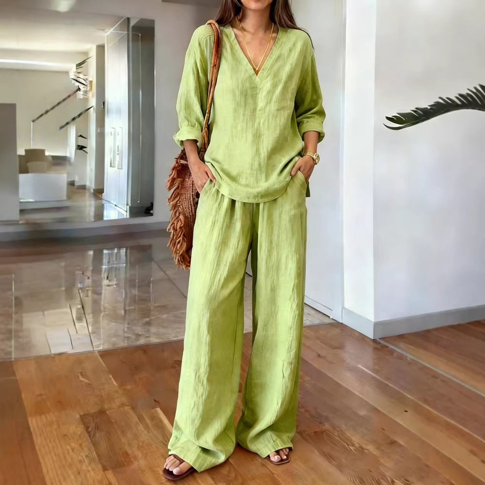 Woman wearing a green outfit in a modern indoor setting