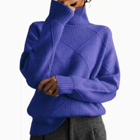 Blue turtleneck sweater worn by a person on a white background