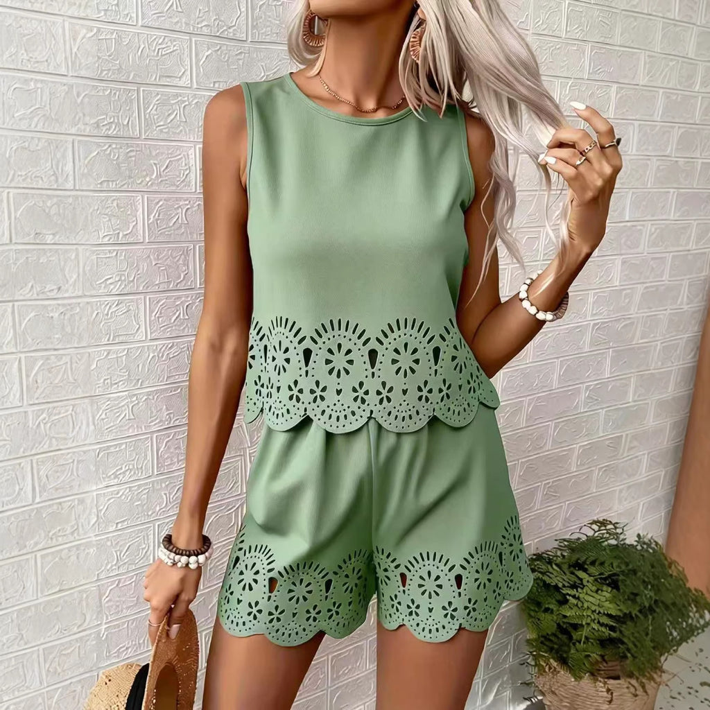 Woman wearing a green outfit with lace details against a white brick wall.