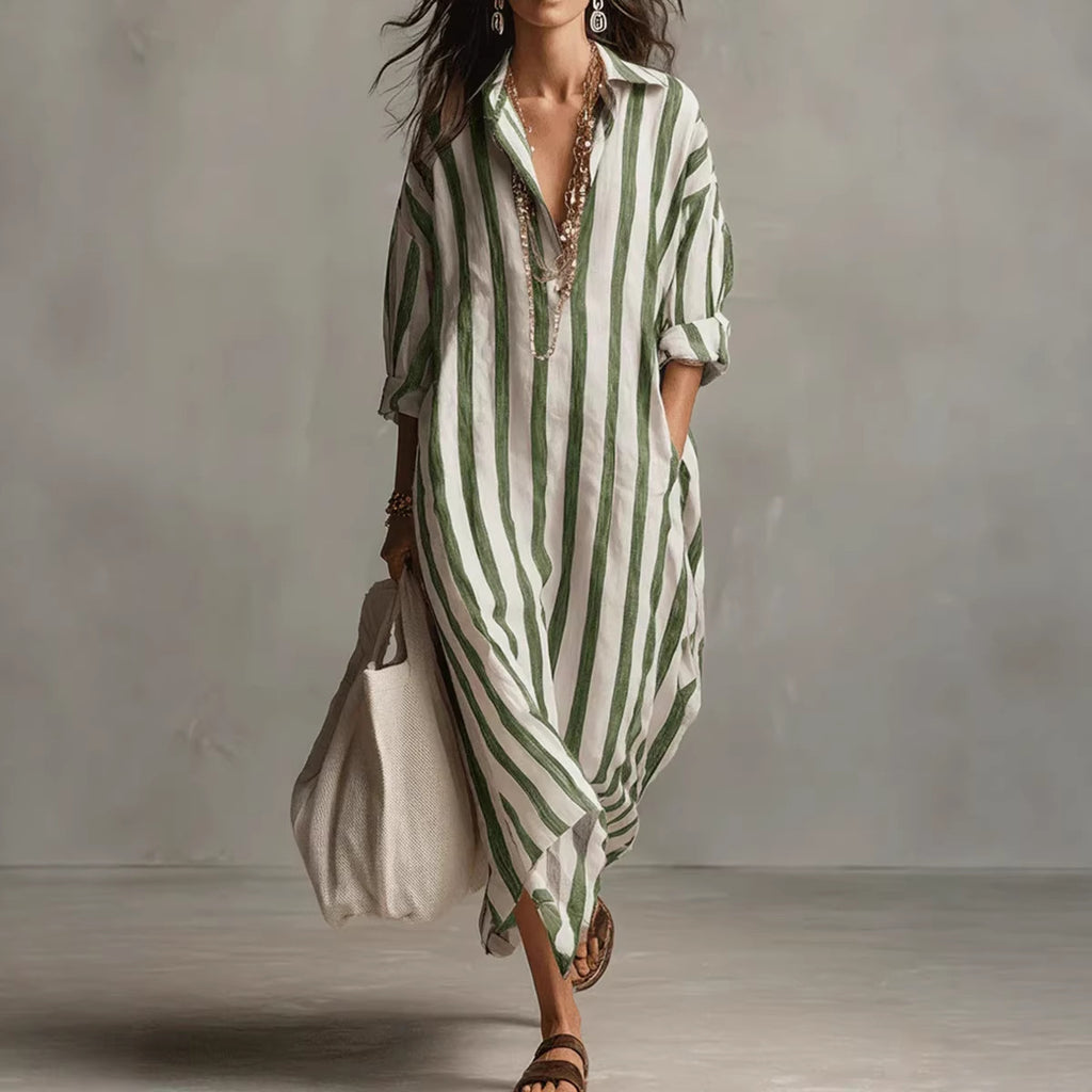 Woman wearing a green and white striped dress against a plain background