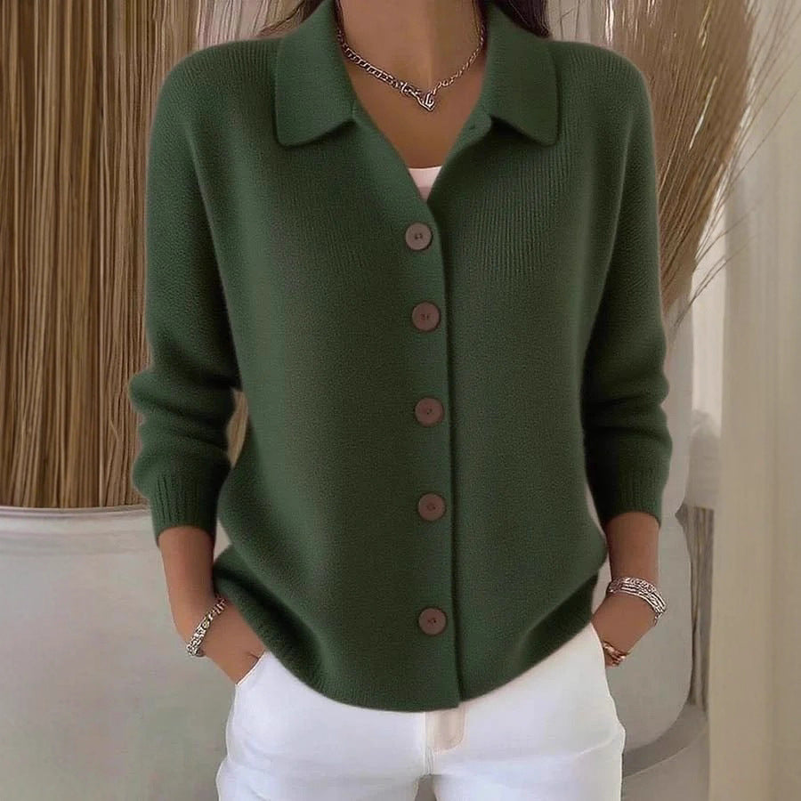 Green button-up cardigan worn by a person with a neutral background