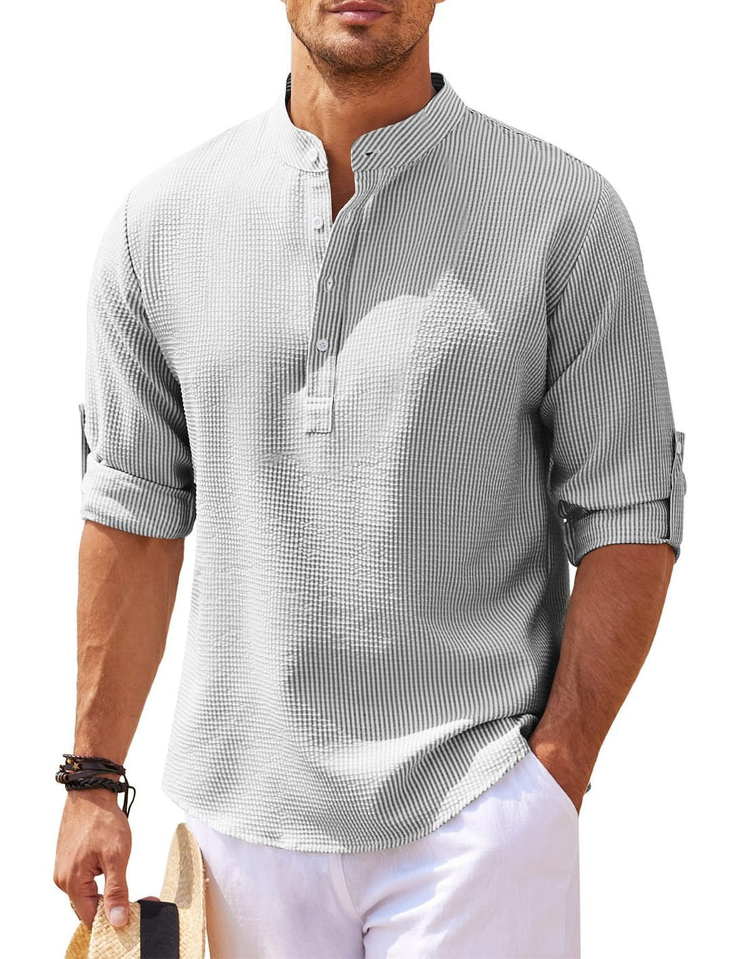 Man wearing a gray checkered shirt with rolled-up sleeves on a white background