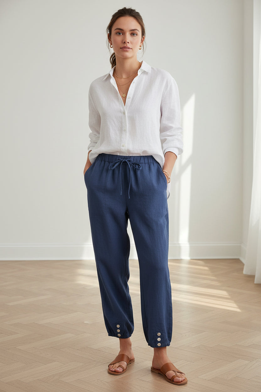 Navy blue pants worn by models on a light wooden floor.