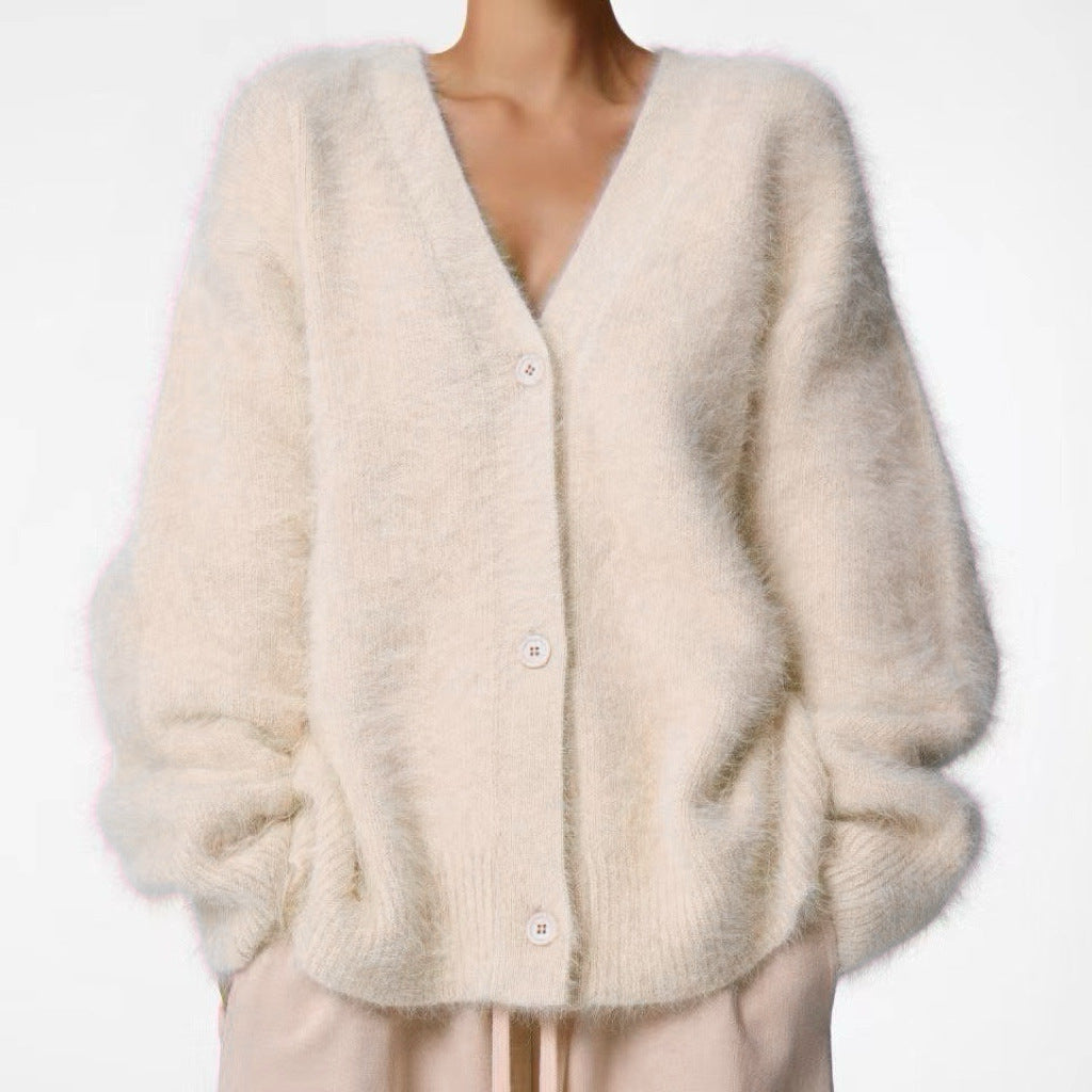 Beige cardigan worn by a person on a white background