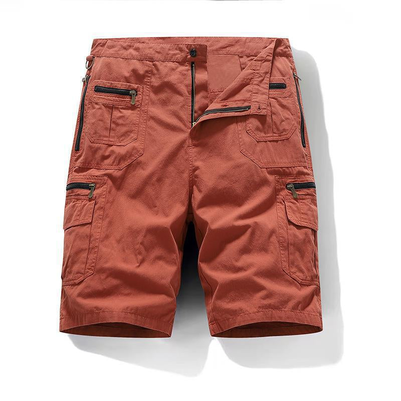Orange cargo shorts with multiple pockets and zippers on a white background