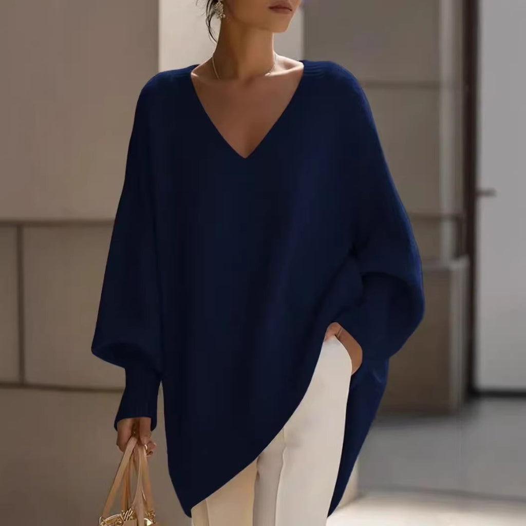 Woman wearing a navy blue poncho in an indoor setting