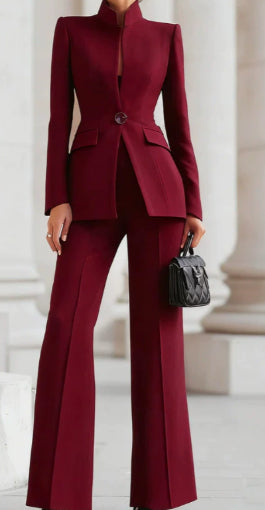 Person wearing a burgundy suit with a blurred background