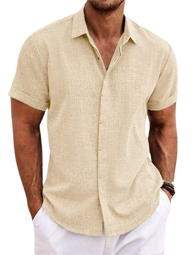Man wearing a beige short-sleeve shirt and white pants on a white background