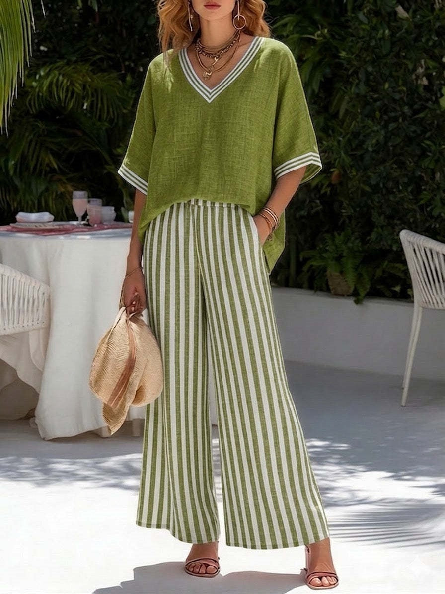 Woman wearing a green outfit with striped pants in an outdoor setting