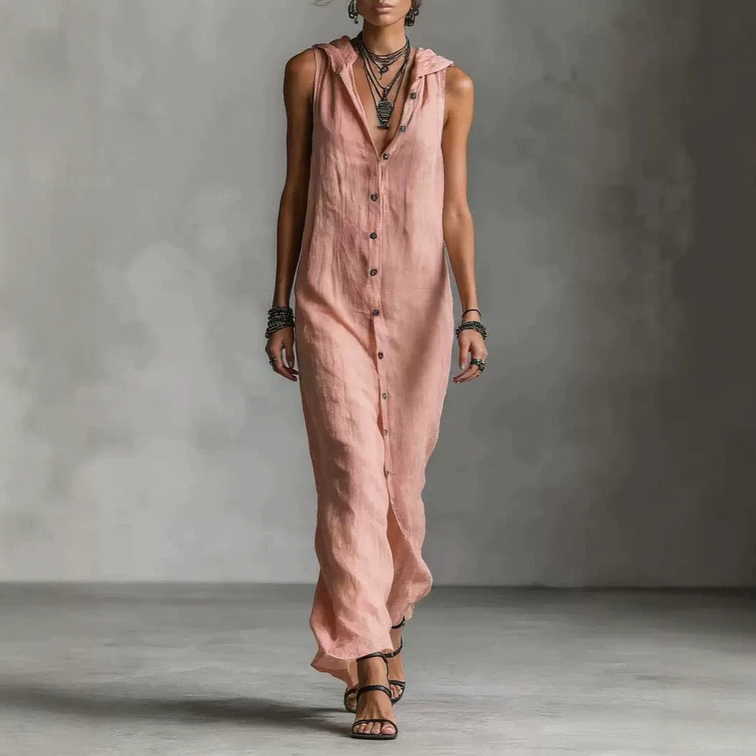 Person wearing a pink sleeveless jumpsuit against a gray background