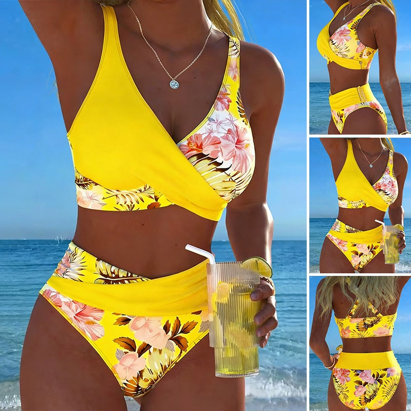 Woman in a yellow floral bikini set holding a drink with ocean view