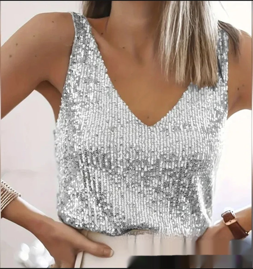 Silver sequin top worn by a person on a plain background